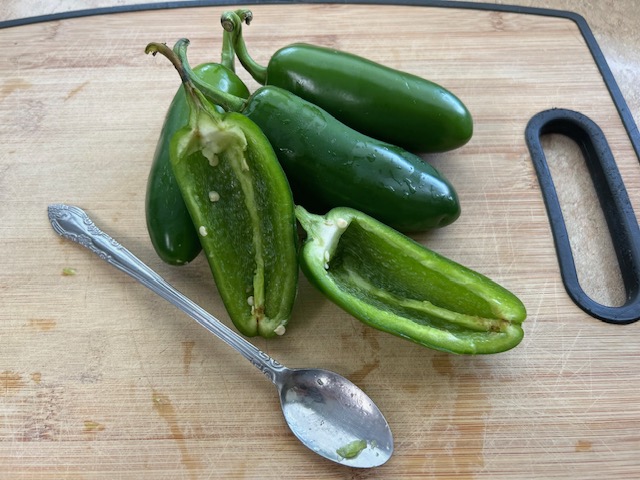 Jalapenos split lengthwise with seeds removed.